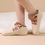 Beige plush socks with reindeer pattern"
