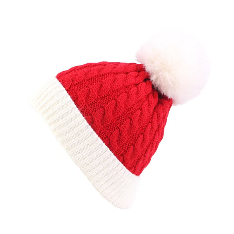 Red Christmas knit beanie with white pom-pom detail"