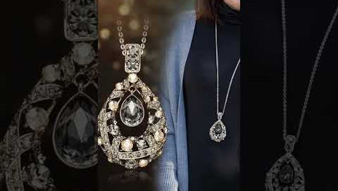 Elegant blue spinel teardrop pendant necklace, featuring a sparkling oval gemstone, surrounded by a halo of glittering rhinestones, close-up view of hand-held display