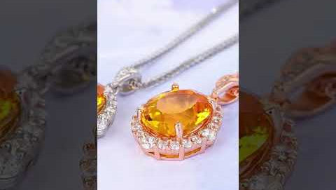 Product demonstration video of elegant yellow citrine halo pendant necklace. Video showcases the vibrant oval-cut yellow citrine center stone surrounded by brilliant cubic zirconia crystals, available in both sterling silver and rose gold plated options. Features close-up views of the gemstone clarity, halo design details, delicate chain, and secure clasp closure. Perfect for birthdays, anniversaries, and special occasions.
