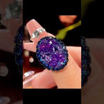 Stunning blue spinel oval pendant necklace showcasing brilliant faceted gemstone with sparkling rhinestone halo in sterling silver setting, displayed from multiple angles with close-up details of the intricate craftsmanship and light reflection
