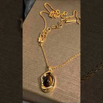 Natural tiger eye stone pendant necklace with gold plated chain - elegant women's jewelry gift unboxing and close-up review showing brown gemstone chatoyant effect
